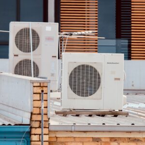 white and gray box fan on brown wooden table